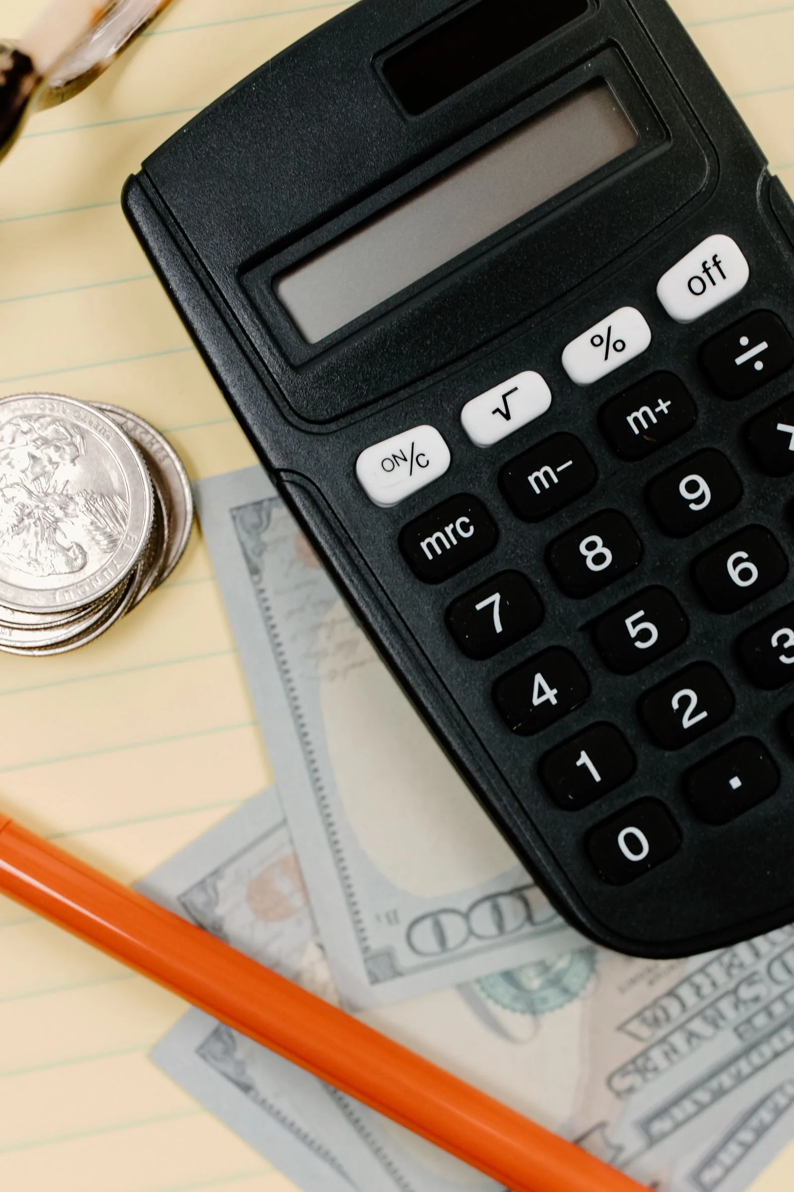Calculator and receipts representing the hidden costs of running finance in-house